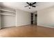 Bright living room with light gray walls, hardwood floors, ceiling fan, and built-in shelving at 9511 E Kiva Ave, Mesa, AZ 85209