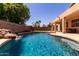 Private backyard oasis with a refreshing pool, rock waterfall, and covered patio for outdoor enjoyment at 9511 E Kiva Ave, Mesa, AZ 85209