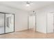 Neutral bedroom with tile flooring, ceiling fan, and access to balcony at 9555 E Raintree Dr # 1018, Scottsdale, AZ 85260