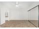 Bright bedroom with mirrored closet doors, neutral tile flooring, and ceiling fan at 9555 E Raintree Dr # 1018, Scottsdale, AZ 85260