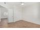 Bedroom with tile flooring, ceiling fan, and view to hallway, closet, and exterior window at 9555 E Raintree Dr # 1018, Scottsdale, AZ 85260