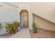 Close up of a unit entrance with neutral paint, decorative plants, and an inviting, covered entry way at 9555 E Raintree Dr # 1018, Scottsdale, AZ 85260