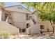 Inviting multi-story condo with a well maintained facade, mature landscaping, and convenient access to various units at 9555 E Raintree Dr # 1018, Scottsdale, AZ 85260