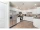 Well-lit kitchen showcasing stainless steel appliances, including a modern refrigerator, white cabinets, and stylish countertops at 9555 E Raintree Dr # 1018, Scottsdale, AZ 85260