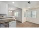 Bright eat-in kitchen featuring a chandelier, granite countertops, tile floors, and seamless flow into the dining area at 9555 E Raintree Dr # 1018, Scottsdale, AZ 85260