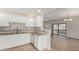 Open kitchen with granite countertops, tile backsplash, white cabinetry, and seamless flow into the adjacent living area at 9555 E Raintree Dr # 1018, Scottsdale, AZ 85260