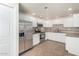 Bright kitchen featuring stainless steel appliances, white cabinetry, tiled backsplash, and sleek countertops at 9555 E Raintree Dr # 1018, Scottsdale, AZ 85260