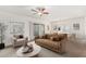 Stylized living room with fan, sliding door, and dining area staged with seating at 9555 E Raintree Dr # 1018, Scottsdale, AZ 85260