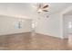 Open-concept living area with fan, window, and neutral tile flooring at 9555 E Raintree Dr # 1018, Scottsdale, AZ 85260