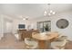 Staged living room with dining area including table, chairs and furniture pieces at 9555 E Raintree Dr # 1018, Scottsdale, AZ 85260