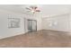 Spacious living room features neutral paint, fan and sliding glass door to patio at 9555 E Raintree Dr # 1018, Scottsdale, AZ 85260