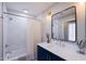 Stylish bathroom with a navy vanity, modern fixtures, and a shower-tub combination at 10017 E Mountain View Rd # 1087, Scottsdale, AZ 85258