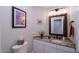 Charming bathroom with a granite countertop, decorative mirror, and ample natural light at 10017 E Mountain View Rd # 1087, Scottsdale, AZ 85258