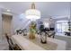 Dining area featuring stylish chandelier, table setting, and nearby stairway at 10017 E Mountain View Rd # 1087, Scottsdale, AZ 85258