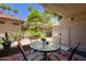 Cozy patio area with table, chairs, and colorful rug, ideal for relaxing outdoors at 10017 E Mountain View Rd # 1087, Scottsdale, AZ 85258