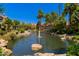 Scenic pond with a fountain, lush greenery, and a gazebo, creating a peaceful and inviting outdoor space at 10017 E Mountain View Rd # 1087, Scottsdale, AZ 85258