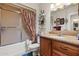 Compact bathroom with shower-tub combination and vanity with storage at 11012 W Caron Dr, Sun City, AZ 85351