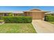Charming brick home with a well-maintained lawn and mature landscaping at 11012 W Caron Dr, Sun City, AZ 85351