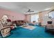 Comfortable living room with ceiling fan and large window providing natural light at 11012 W Caron Dr, Sun City, AZ 85351