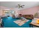 Inviting living room with pink walls, plush carpeting, and comfortable seating at 11012 W Caron Dr, Sun City, AZ 85351