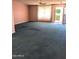 A spacious living room features a ceiling fan, a large window, and an open entryway at 11012 W Caron Dr, Sun City, AZ 85351