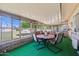 Enclosed sunroom with a dining table set, ideal for year-round enjoyment at 11012 W Caron Dr, Sun City, AZ 85351