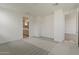 Bright, carpeted bedroom with an open doorway to the bathroom at 11300 N Casa Dega N Dr # 1047, Surprise, AZ 85388