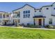 Exterior view of a contemporary townhome showcasing its clean lines, and manicured lawn at 11300 N Casa Dega N Dr # 1047, Surprise, AZ 85388