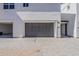 Exterior view of modern townhouse showcasing garage door, pavers, and address marker at 11300 N Casa Dega N Dr # 1047, Surprise, AZ 85388