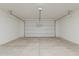 Spacious two-car garage features an automatic door and ample room for vehicles and storage at 11300 N Casa Dega N Dr # 1047, Surprise, AZ 85388