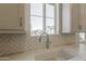 A sink with light backsplash and a window showing an external view at 11300 N Casa Dega N Dr # 1047, Surprise, AZ 85388