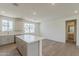 Open kitchen featuring a large island, stainless steel appliances, and hardwood floors at 11300 N Casa Dega N Dr # 1047, Surprise, AZ 85388