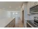 Open concept kitchen with an island, hardwood floors, and access to the living room at 11300 N Casa Dega N Dr # 1047, Surprise, AZ 85388