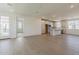 Open-concept living area featuring hardwood floors, white walls, and a bright kitchen at 11300 N Casa Dega N Dr # 1047, Surprise, AZ 85388