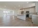 Open concept kitchen and living room with hardwood floors and lots of natural light at 11300 N Casa Dega N Dr # 1047, Surprise, AZ 85388