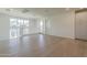 Spacious living room featuring hardwood floors, bright natural light, and access to a balcony at 11300 N Casa Dega N Dr # 1047, Surprise, AZ 85388