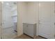 Functional mud room with storage cabinets and tile flooring, leading to laundry room at 11300 N Casa Dega N Dr # 1047, Surprise, AZ 85388
