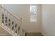 Carpeted staircase with white banister and a bright window that provides natural light at 11300 N Casa Dega N Dr # 1047, Surprise, AZ 85388