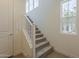 Bright staircase leads to the second level with large windows and hardwood flooring at 11300 N Casa Dega N Dr # 1047, Surprise, AZ 85388
