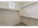 Walk-in closet with neutral carpet and built-in shelving racks at 11300 N Casa Dega N Dr # 1047, Surprise, AZ 85388