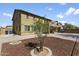 Large backyard with a mulched area, patio, and a two-story home as the backdrop at 11959 W Vernon Ave, Avondale, AZ 85392