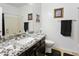 Clean bathroom with granite countertops, modern vanity, and neutral color scheme at 11959 W Vernon Ave, Avondale, AZ 85392