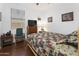 Cozy bedroom with wooden floors, natural light, and cabin-themed decor at 11959 W Vernon Ave, Avondale, AZ 85392