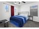 Bedroom featuring neutral walls, carpet flooring, and a blue-themed bed at 11959 W Vernon Ave, Avondale, AZ 85392