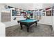 This spacious game room is complete with a pool table, hockey memorabilia, and bright window at 11959 W Vernon Ave, Avondale, AZ 85392