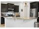 Modern kitchen with granite countertops, stainless steel appliances, and dark cabinetry at 11959 W Vernon Ave, Avondale, AZ 85392