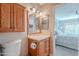 Cozy bathroom with a wooden vanity, framed mirror, and neutral walls at 14300 W Bell Rd # 58, Surprise, AZ 85374