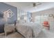 Comfortable bedroom with a stylish bed, soft lighting, and calming blue accent wall at 14300 W Bell Rd # 58, Surprise, AZ 85374