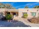 Charming single story home showcasing desert landscaping, shade trees and covered front porch entry at 14300 W Bell Rd # 58, Surprise, AZ 85374