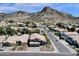 A desert community featuring neutral colored homes with tile roofs, mature desert landscaping, and majestic mountains in the background at 14823 S 13Th Pl, Phoenix, AZ 85048